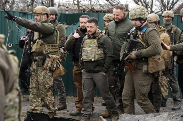 Ukrainian President Volodymyr Zelenskyy examines the site of a recent battle in Bucha.