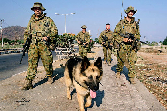 Australian soldiers patrol Dili.