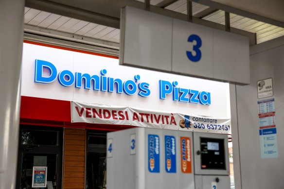 A “for sale” banner outside a closed down Domino’s Pizza store in Rome.