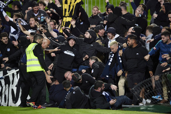 Victory fans spill onto the turf.