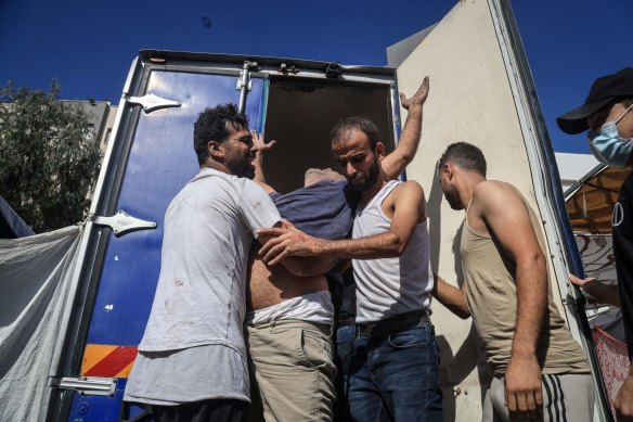 A Palestinian man reacts with emotion following Israeli airstrikes on the al-Fakhoora district of Jabalia.