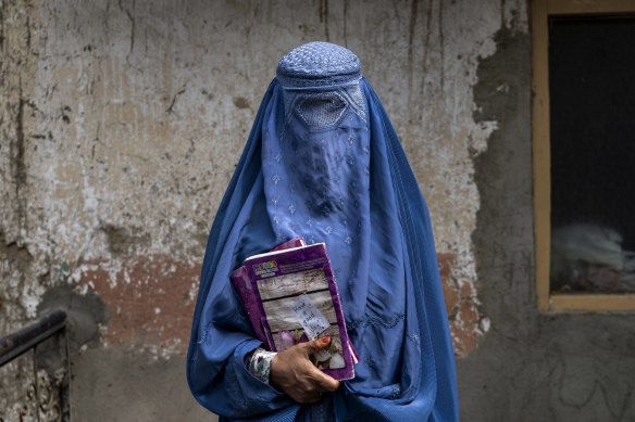 An Afghan woman leaves an underground school, in Kabul.