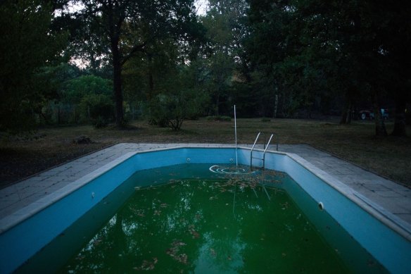 Water pumped from a property’s swimming pool as farmers attempt to extinguish a fire next to homes in Hostens, Gironde, France, in July.