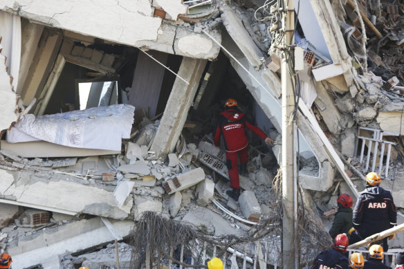 Rescuers search for people buried under the rubble at a collapsed building in Elazig, eastern Turkey on Saturday.
