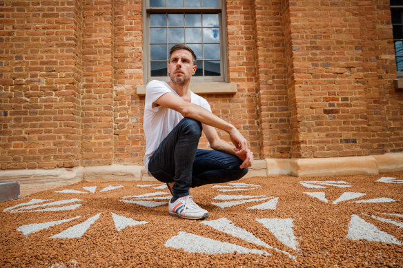 Jonathan Jones at Hyde Park Barracks with his 2020 installation featuring emu footprints. 
