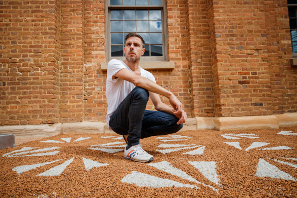 Jonathan Jones at Hyde Park Barracks with his 2020 installation featuring emu footprints.