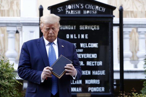 Donald Trump with a Bible in hand at St John’s Park in Washington DC  in June.