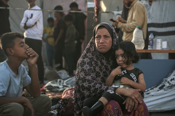 A Palestinian woman and children in the courtyard of the Al Aqsa Martyrs Hospital in Deir al-Balah, central Gaza, following an Israeli strike.