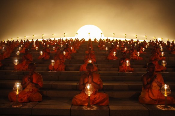 Thousands of Thai Buddhist monks chant during lantern lighting to celebrate Makha Bucha day, at the Wat Phra Dhammakaya Temple in Pathum Thani province, on the outskirts of Bangkok.