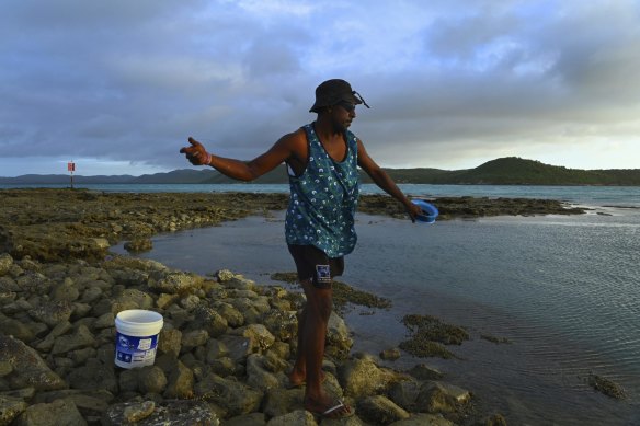 Gabriel Gesa fishing for parrot fish on the Bach Beach on Thursday Island in the late afternoon.
