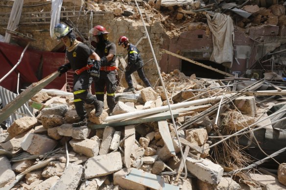 Emergency workers search a collapsed building in Beirut, Lebanon. 