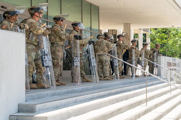 National Guard members stand outside the Edward R. Roybal Federal Building in Los Angeles on Monday.