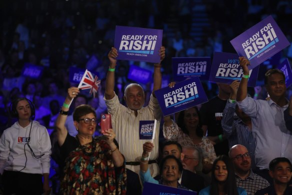 Rishi Sunak supporters hold placards during a Conservative Party leadership hustings in London on August 31.
