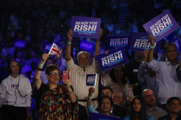 Rishi Sunak supporters hold placards during a Conservative Party leadership hustings in London on August 31.