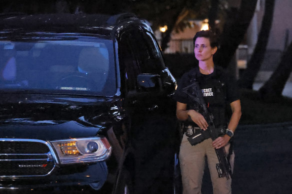 An armed Secret Service agent stands outside an entrance to former president Donald Trump’s Mar-a-Lago estate, in Palm Beach, Florida.