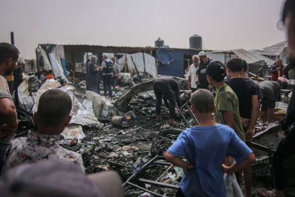 Palestinians at the site of an Israeli strike on an area designated for displaced people in Rafah on Monday.