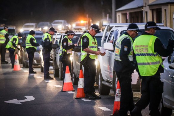 NSW Police stop and question drivers at a checkpoint on the NSW-Victoria border in Albury.