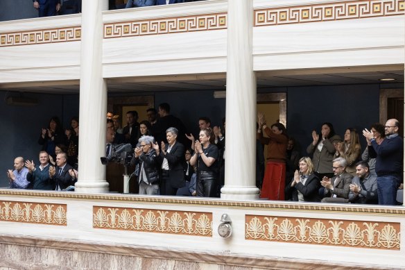 Visitors applaud after the landmark vote on the same-sex marriage bill in parliament in Athens.