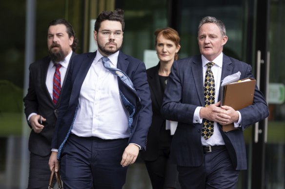 Bruce Lehrmann (second left) departs the ACT Supreme Court in Canberra on October 25, 2022.