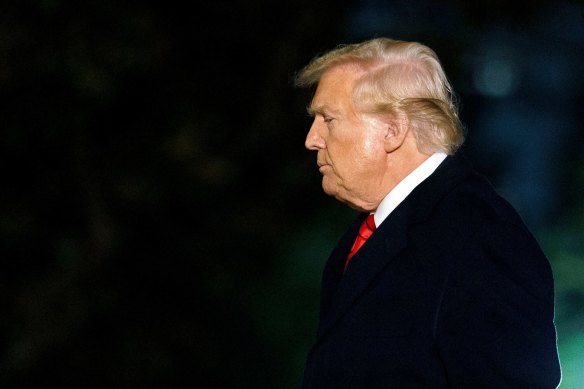 US President Donald Trump walks on the South Lawn of the White House after returning from Florida on Monday night.