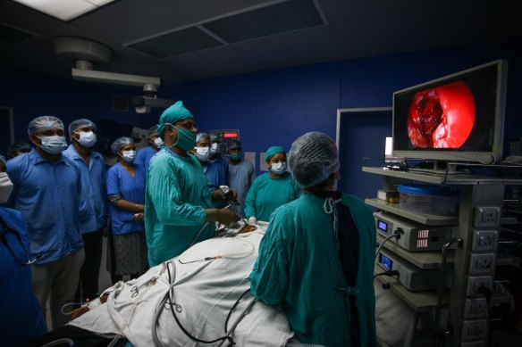 A specialist removes mucormycosis from a recovering COVID patient in Allahabad, India. 