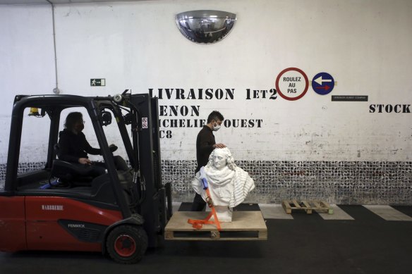 Workers transport a bust of Guillaume de Lamoignon by French sculptor Francois Girardon in the Paris Louvre museum, where a forced closure has granted museum officials a golden opportunity to carry out long-overdue refurbishments. 