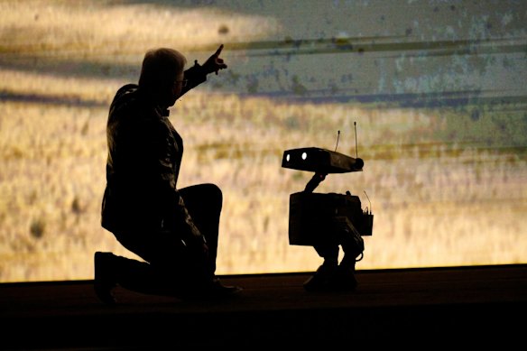 Huang on stage with a small robot during the Nvidia Live event at the CES.