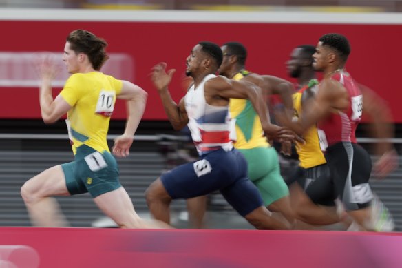 Rohan Browning, left, of Australia, leads the field in his heat of the men’s 100m.