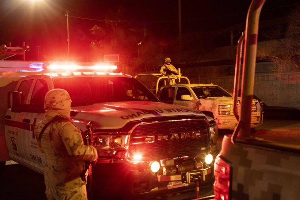 Members of the Mexican Army guard outside the National Migration Institute after the fire.