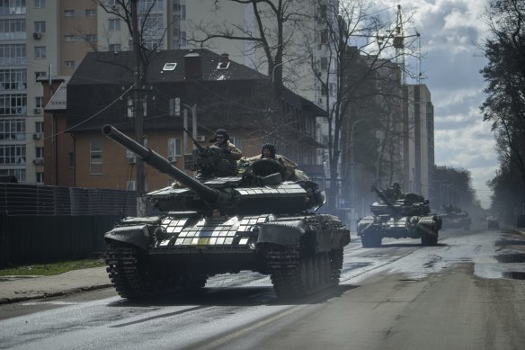 Ukrainian tanks move down a street in Irpin, on the outskirts of Kyiv, following the Russian withdrawal.