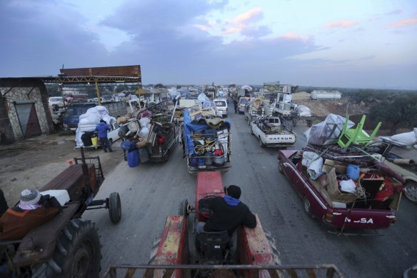 Truckloads of civilians flee a Syrian military offensive in Idlib province on the main road near Hazano, Syria, last week.