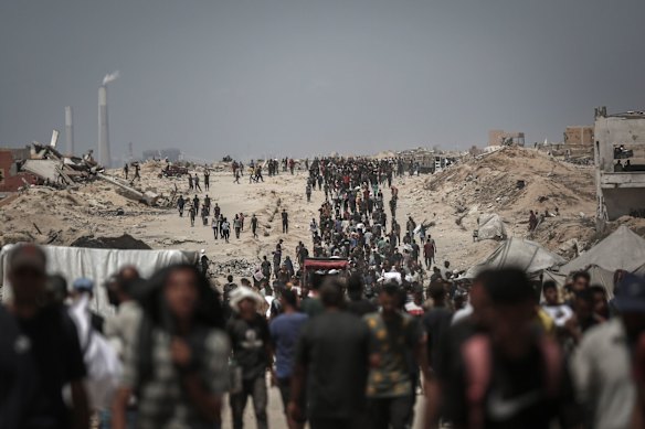 Palestinians gather to collect humanitarian aid from a distribution point in Beit Lahia, northern Gaza.
