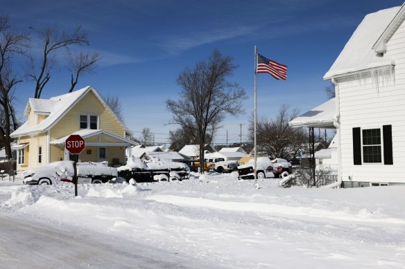 Snow-covered vehicles in a residential neighbourhood on the day of the Iowa Caucus in Cedar Rapids, Iowa.