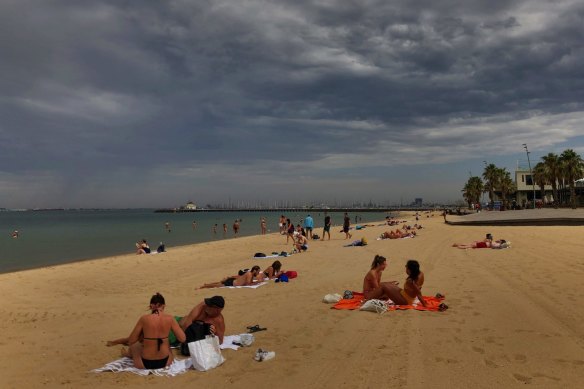 Beachgoers in St Kilda today.