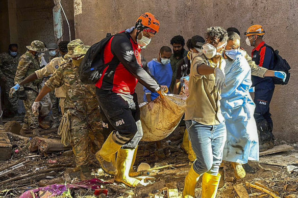 Rescuers retrieve the body of a flooding victim in Derna.