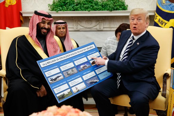 Then-US president Trump shows a chart highlighting arms sales to Saudi Arabia during a meeting with Crown Prince Mohammed bin Salman in the Oval Office in 2018.