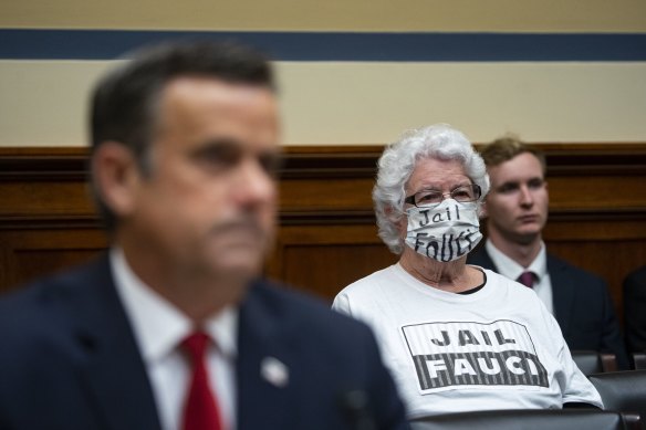 A protester sits in a congressional hearing into the origins of the pandemic, in Washington in April.