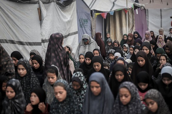 Displaced Palestinian women perform Eid prayers near temporary shelters in Gaza City on Friday.