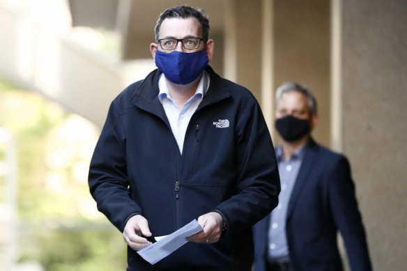 Premier Daniel Andrews, flanked by Chief Health Office Brett Sutton, arrives at Sunday's press conference.