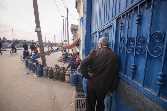 Palestinians queue to refill gas bottles in Salah al-Din in central Gaza Strip on Monday.