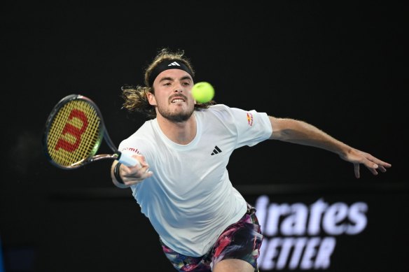 Stefanos Tsitsipas stretches for the ball.