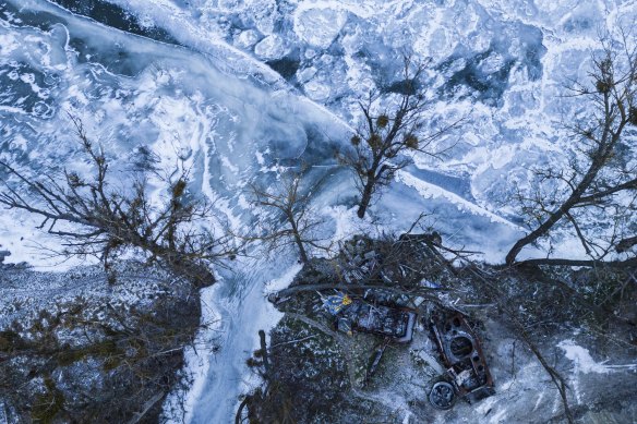 Armored vehicles destroyed during the fighting between Ukrainian and Russian armed forces stand on the right bank of the frozen Siverskiy-Donets river in the recently liberated village of Bogorodychne. 