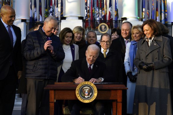 US President Joe Biden signs the Respect for Marriage Act during a ceremony on the South Lawn of the White House in Washington.