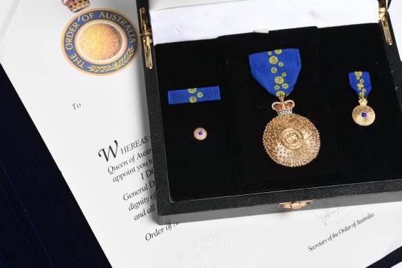 A boxed set of a lapel pin, a smaller medal and a full-size medal. 