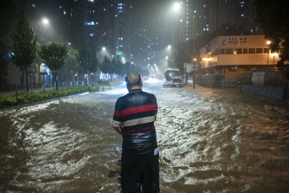 A pedestrian negotiates floodwaters in Hong Kong, China, on Friday.