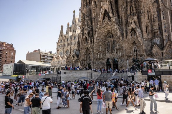 Tourists visit the Sagrada Familia church in Barcelona.