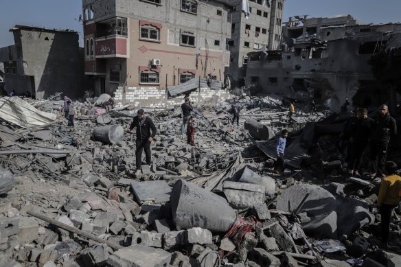 Palestinians inspect damage following an Israeli airstrike east of Gaza City on Tuesday.