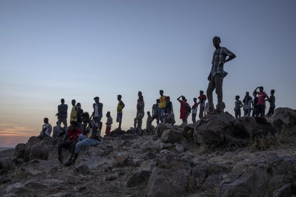 Tigray people who fled the conflict in Ethiopia's Tigray region, stand on a hill top overlooking Umm Rakouba refugee camp in Qadarif, eastern Sudan, on Thursday.