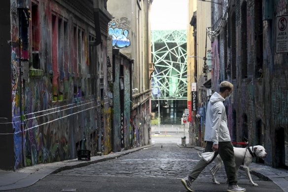 A man walks past Melbourne’s Hosier Lane during lockdown last August.