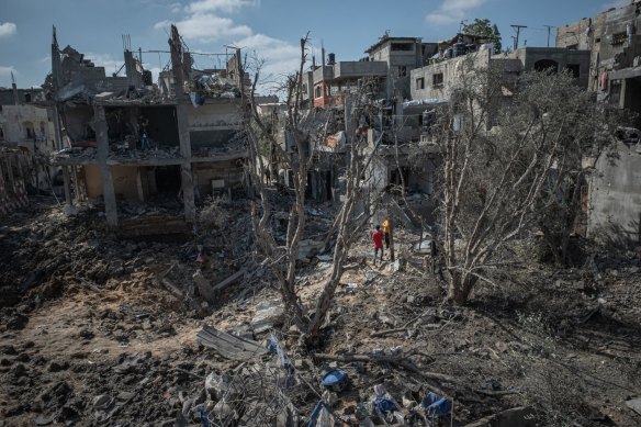 People inspect the damage in Beit Hanoun, Gaza City, after a night of Israeli raids.
